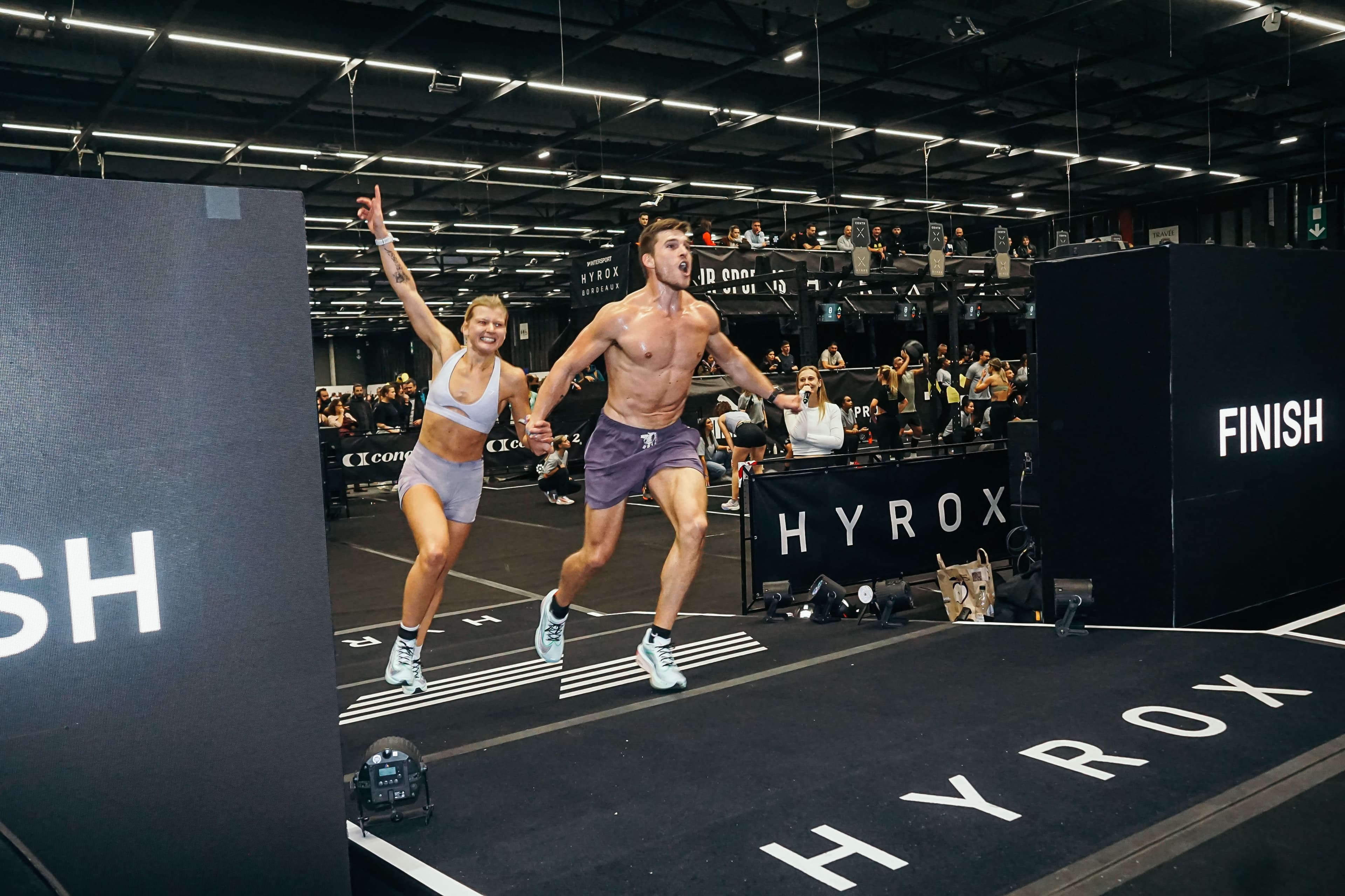 Frederik crossing the HYROX finish line with his doubles partner